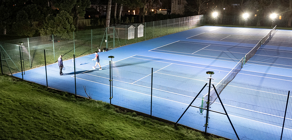 Oundle School Ritelite Sports-LITE training fence adapters lighting up a twin tennis court for winter practice